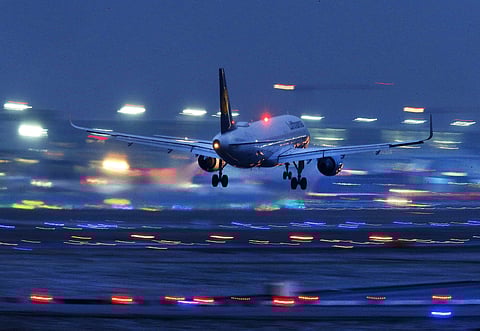 A plane takes off amid hazy runway lights creating a pretty picture. (Photo: PTI)