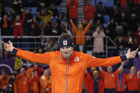 Gold medallist and new Olympic record holder Sven Kramer of The Netherlands motion for fans to cheer as he is about to jump on the podium after the men's 5,000 meters race at the Gangneung Oval at the 2018 Winter Olympics in Gangneung. | AP
