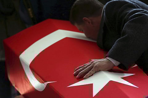A family member kisses the flag-covered coffin of a Turkish soldier killed in the Syrian operation | AP
