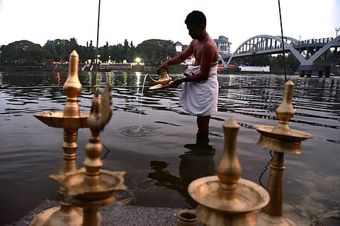 A priest cleans 'kuthuvilakku' before the Shivaratri celebrations in Aluva Manappuram. (Albin Mathew| EPS)