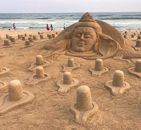 ​ Artist Sudarsan Pattnaik creates sand sculpture of 108 Shivalingas on the eve of Mahashivaratri on Puri beach on Tuesday | Express ​