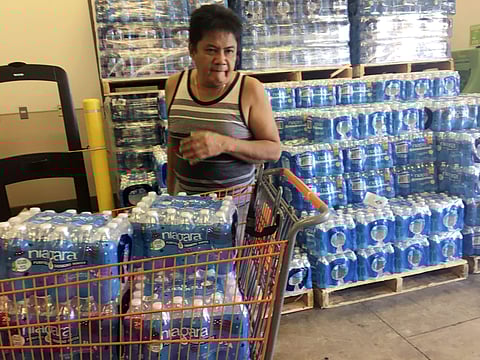 A file image of a resident of Guam buying bottles of water at Home Depot in Guam Saturday, Aug. 12, 2017.  After North Korea's nuclear threat, residents of  this small U.S. territory started preparing  for possible missile strike. ( Photo | AP)
