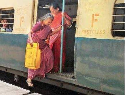 An elderly passenger struggling to alight from a suburban train. (Photo | EPS)