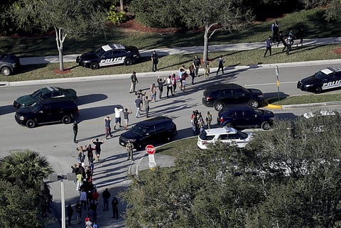 A former student armed with an AR-15 rifle opened fire at a Florida high school on Wednesday, killing at least 17 people, officials said, in a harrowing shooting spree that saw terrified students hiding in closets and under desks as they texted for help. 