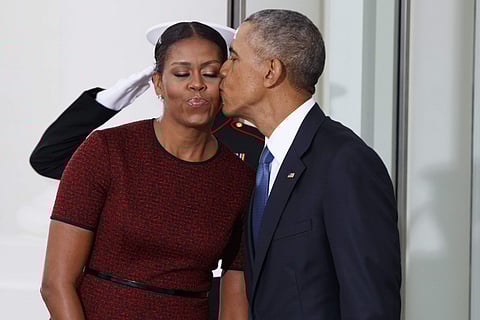 Former US President Barack Obama kisses first lady Michelle Obama | AP