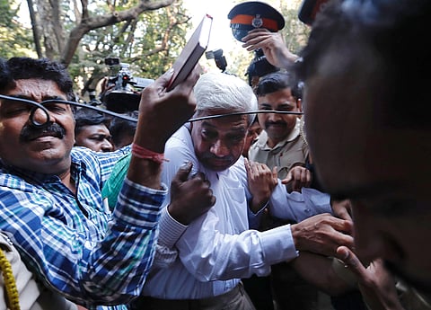 Police escort a man suspected of steering fraudulent loans to companies linked to billionaire jeweller Nirav Modi, at a court in Mumbai, India, February 17, 2018. REUTERS/Danish Siddiqui