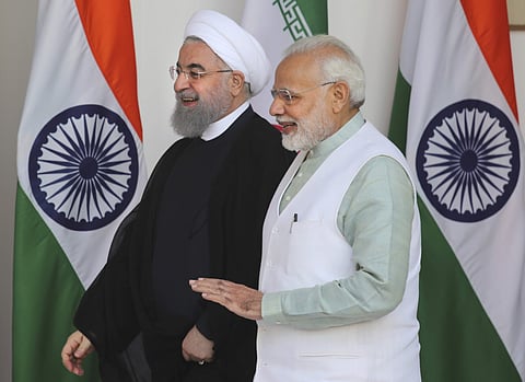 Indian PM Narendra Modi talks with Iranian President Hassan Rouhani as they walk for their delegation level meeting in New Delhi | AP