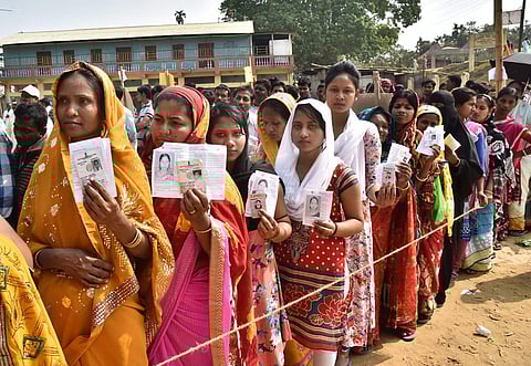 Voters wait in queue to cast their votes at a polling booth during Tripura Assembly elections in Raj Nagar Agartala on Sunday. | PTI