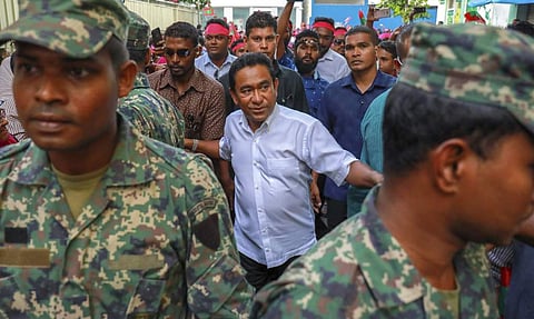 FILE- In this Feb. 3, 2018, file photo, Maldivian President Yameen Abdul Gayoom, center, surrounded by his body guards arrives to address his supporters in Male, Maldives. | AP