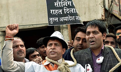 Traders raise anti-government slogans during the 48-hour bandh against MCD's ongoing sealing at Chandni Chowk area of New Delhi on Friday. (PTI)