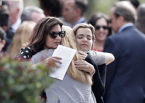 Mourners hug as they leave the funeral of Alaina Petty, in Coral Springs, Fla. | AP