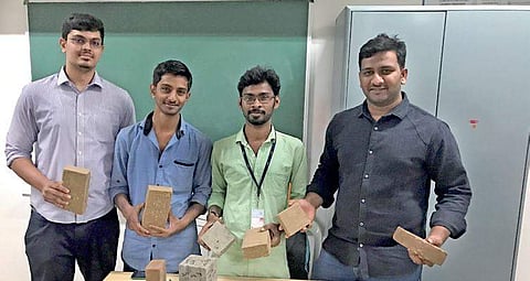 The team of of former students from CMRIT holidng their invention