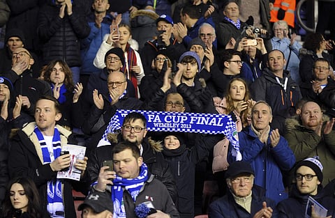 Wigan Athletic fans support their team prior to the English FA Cup fifth round match between Wigan Athletic and Manchester City at The DW Stadium in Wigan, England. (AP)