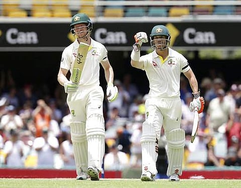 Australia's David Warner, right, and Cameron Bancroft walk off the field after winning the match against England during their Ashes cricket test in Brisbane.|AP