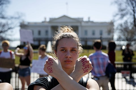A student joins the protest outside the White House | AP