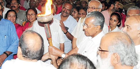 Chief Minister Pinarayi Vijayan lighting the torch brought from various memorials at the Thekkinkad ground prior to the 22nd CPM state conference in Thrissur on Wednesday | Express
