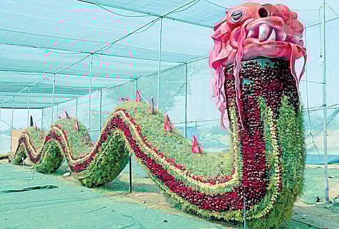 A floral replica of a dragon on display at the flower show in Shravanabelagola