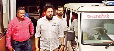 Officials leading MM Akbar, managing director of Kozhikode-based Peace Educational Foundation, at Rajiv Gandhi International Airport on Sunday | albin mathew