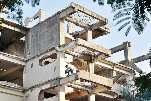 A building being demolished as part of Metro rail constructiion at Jubilee Hills X road, in Hyderabad on Monday | R satish Babu