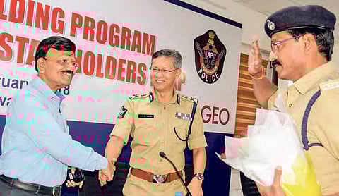 Collector B Lakshmiknatham shakes hands with police commissioner, Gautam Sawang, at the session here on Monday |Express