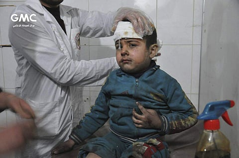 A Syrian paramedic treats a kid who was wounded during an airstrike. (Photo | AP)