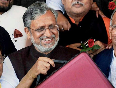 Bihar Deputy Chief Minister Shushil Kumar Modi arrives to present the state budget 2018-19 in the state Assembly in Patna on Tuesday. (PTI)