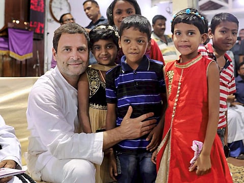Congress President Rahul Gandhi pose with children during his visit to Basel Mission Church Hubli Karnataka on Monday | pti
