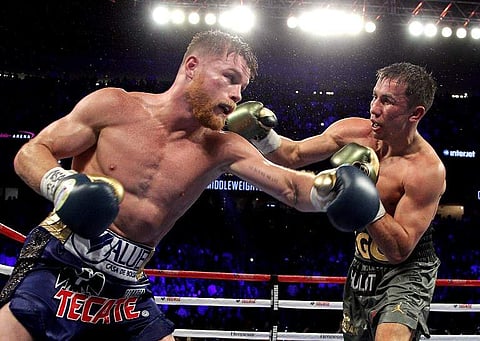 Gennady Golovkin (R) exchanges blows with Canelo Alvarez (L) during their WBC, WBA and IBF middleweight championship fight at the T-Mobile Arena on September 16, 2017 in Las Vegas, Nevada. (File | AFP)