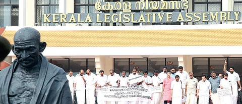 UDF MLAs, holding a banner, coming out of the Assembly after disrupting proceedings on Tuesday | Express