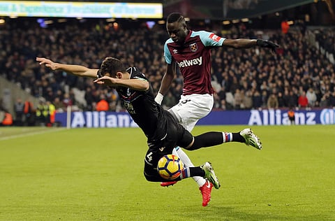 Crystal Palace's Luka Mlivojevic, left falls as he vies for the ball with West Ham United's Cheikhou Kouyate during their English Premier League soccer match. | AP