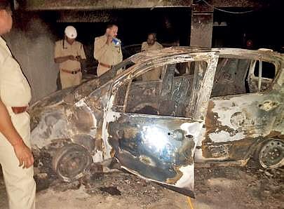 The charred remains of the car in the basement of Sumadhura Anandam Apartment in Whitefield | Express