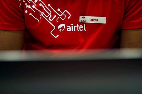 An employee works at a billing counter inside a Bharti Airtel store in New Delhi. (Photo | Reuters)