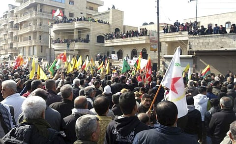 This photo released by the press office of the Kurdish militia, People's Protection Units or YPG, shows protesters holding flags of the YPG and Kurdish parties, during a demonstration against the Turkish assault on Afrin. |AP