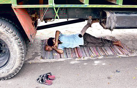 As the temperature rises, a man rests under a truck in Bhubaneswar on Tuesday | Express