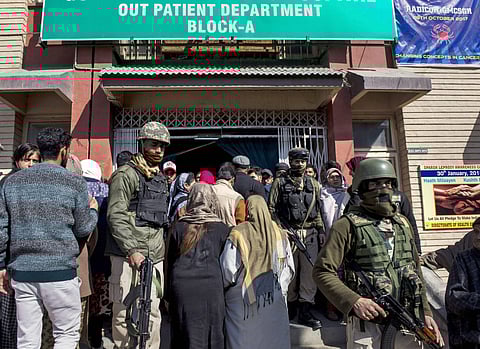 Security personnel stand guard during a search operation after an LeT militant escaped from the police custody with the assailants after Lashkar-e-Taiba militants attacked SMHS hospital in Srinagar on Tuesday. (PTI)