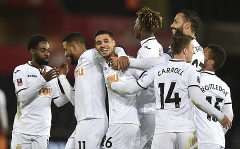 Swansea City's Kyle Naughton (C) celebrates with his team-mates after scoring his side's fifth goal against Notts County during the Emirates FA Cup, fourth round. | AP
