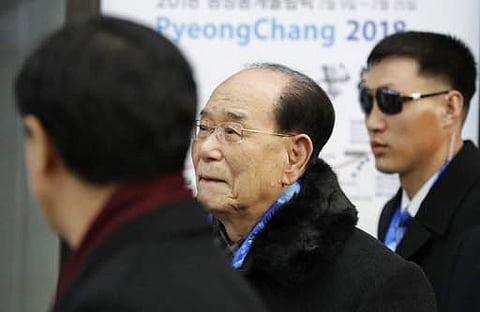 North Korea's nominal head of state Kim Yong Nam, center, arrives with South Korean Unification Minister Cho Myoung-gyon, left, at the Jinbu train station in Pyeongchang. | AP