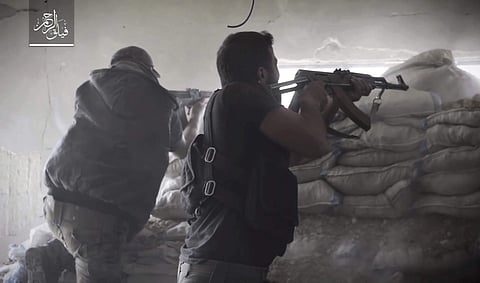 Rebel fighters with Failaq al-Rahman, firing their weapons during clashes with government forces in the suburbs of the Syrian capital Damascus. | AP