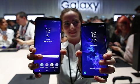 A woman holds the new Galaxy S9 and S9 plus during the Samsung Galaxy Unpacked 2018 event on the eve of the Mobile World Congress wireless show in Barcelona, Spain. File| AP