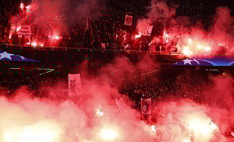 PSG fans set off flares during the Champions League round of sixteen second leg soccer match between Paris St. Germain and Real Madrid at the Parc des Princes stadium. | AP
