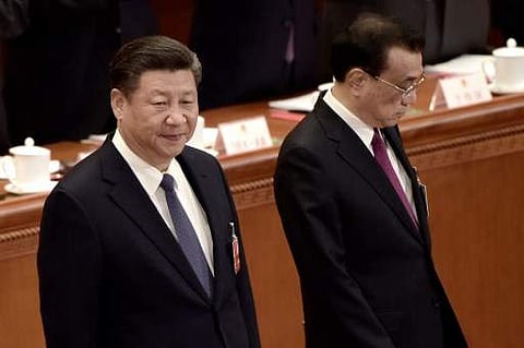 China's President Xi Jinping (L) and China's Premier Li Keqiang (R) arrive for the third plenary session of the first session of the 13th National People's Congress (NPC) at the Great Hall of the People in Beijing on March 11, 2018. | AFP