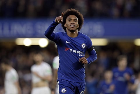 Chelsea's Willian celebrates after scoring the opening goal during the English Premier League soccer match between Chelsea and Crystal Palace at Stamford Bridge stadium in London | Photo: AP