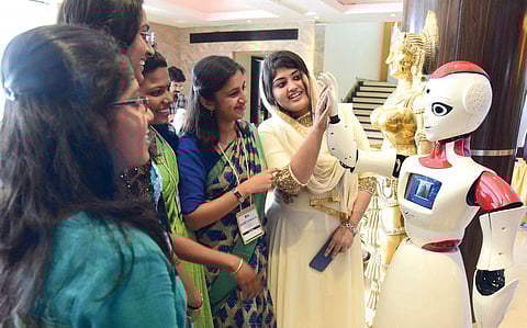 Students are all ears as they interact with a ‘robot’ at ‘Hardtech Kochi’, a national-level hardware conclave, in  Kochi on Saturday (EPS | Albin Mathew)