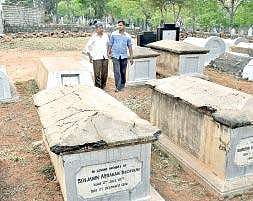 Sheikh Rafiq with his son at the Jewish burial ground  Jithendra M