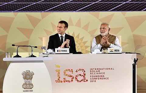 Prime Minister Narendra Modi and French President Emmanuel Macron clap at the International Solar Alliance Founding Conference in New Delhi on Sunday. (PTI)