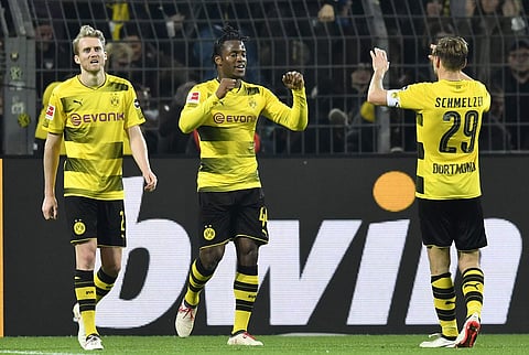 Dortmund's Michy Batshuayi, center, is celebrated after scoring the final goal in the additional time during the German Bundesliga soccer match between Borussia Dortmund and Eintracht Frankfurt in Dortmund. | AP