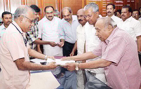 JD(U) leader M P Veerendrakumar files the nomination papers for the Rajya Sabha election in Thiruvananthapuram on Monday as Chief Minister Pinarayi Vijayan and Revenue Minister E Chandrasekharan look on | Express