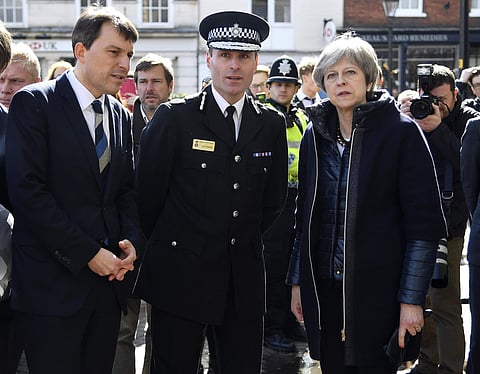 Britain's Prime Minister Theresa May (R) views the area where former Russian double agent Sergei Skripal and his daughter were found critically ill. | AP