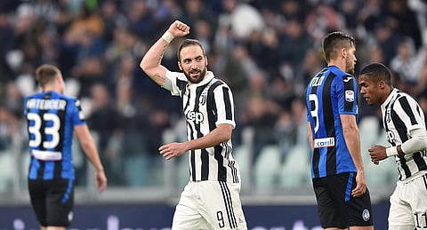 Juventus' Gonzalo Higuain celebrates after scoring his side's first goal during the Italian Serie A soccer match between Juventus and Atalanta at the Allianz Stadium in Turin, Italy, Wednesday, March 14, 2018. | AP