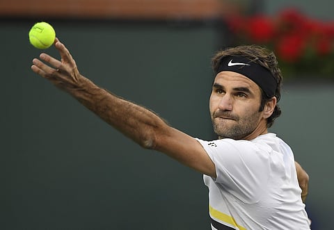 Roger Federer, of Switzerland, serves to Jeremy Chardy, of France, at the BNP Paribas Open tennis tournament. | AP
